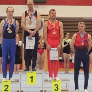 Siegerehrung Seniorenturner in einer Halle mit Podium