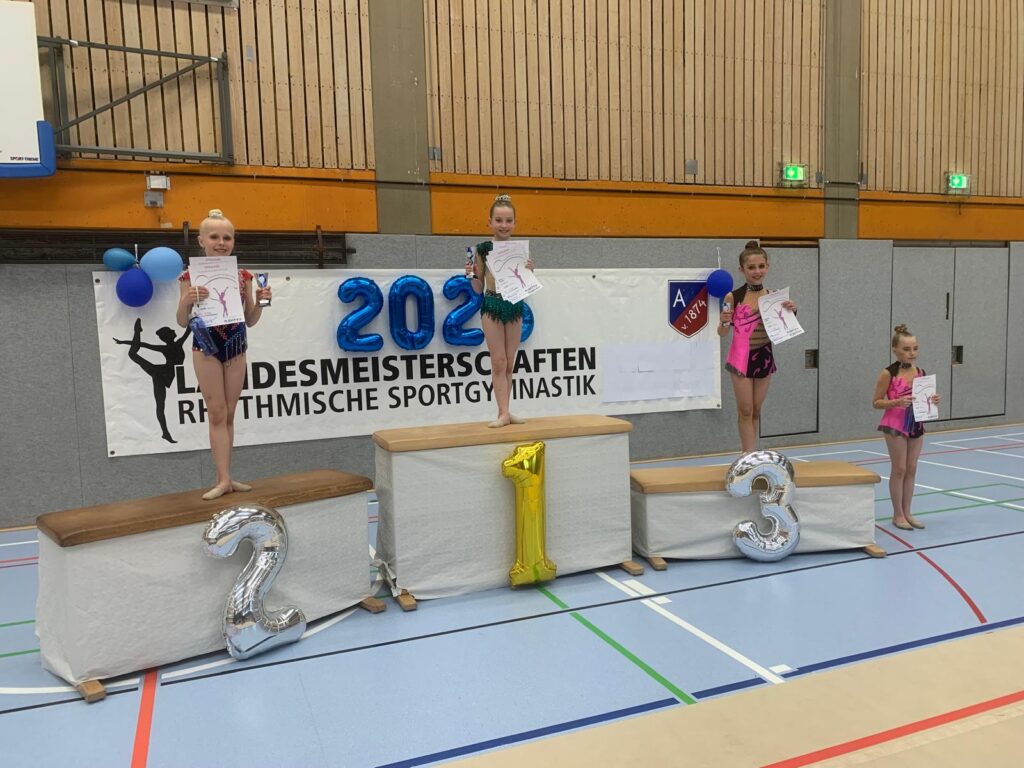Siegerehrung bei einem Turnwettbewerb mit Podestplätzen und Teilnehmerinnen (AK 10), die Urkunden halten.