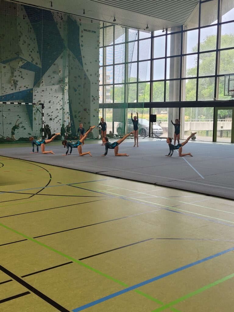 Turnerinnen auf Matte in Turnhalle